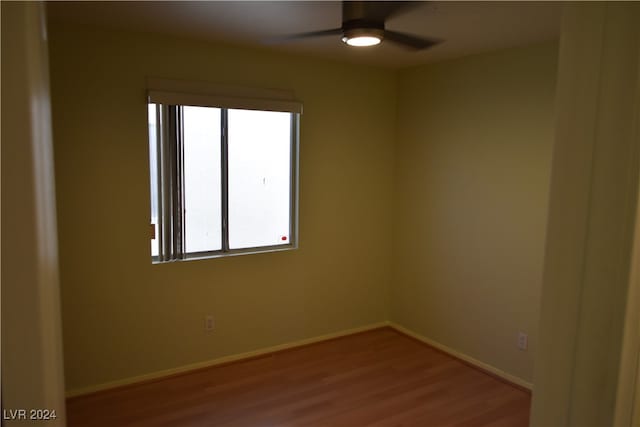 empty room with hardwood / wood-style flooring and ceiling fan