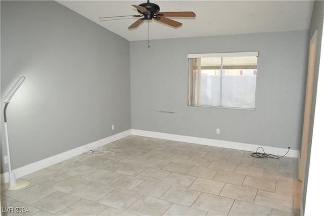 empty room with ceiling fan and light tile patterned flooring