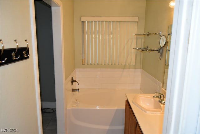 bathroom featuring tile patterned floors, vanity, and a tub