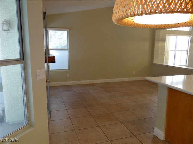 unfurnished dining area featuring light tile patterned floors