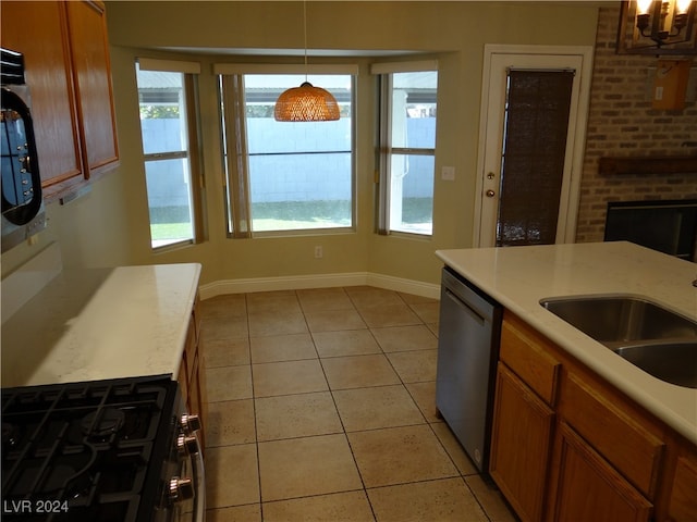 kitchen with dishwasher, sink, light tile patterned floors, decorative light fixtures, and gas stove