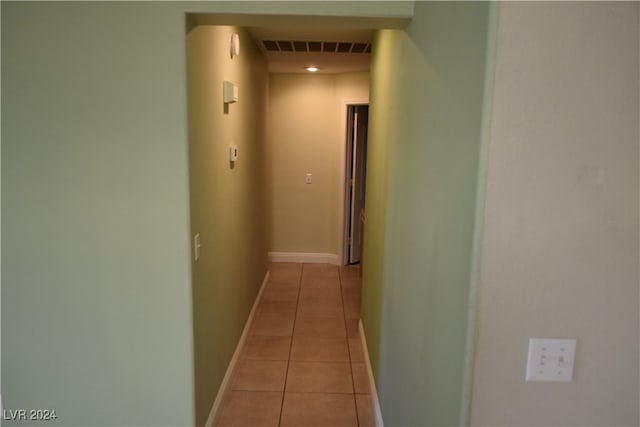 corridor featuring light tile patterned floors