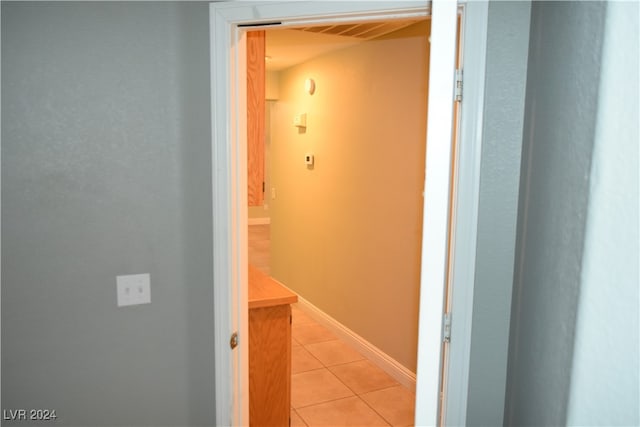 hall featuring light tile patterned flooring