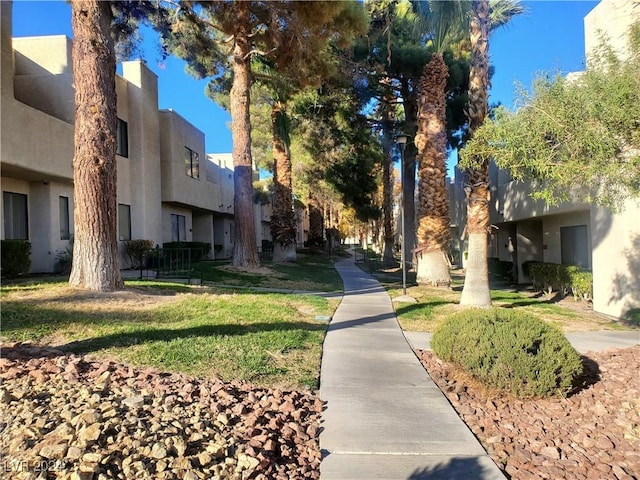 surrounding community with a residential view and a lawn