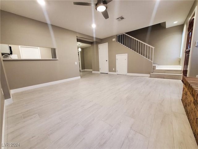 unfurnished living room with ceiling fan and light hardwood / wood-style flooring