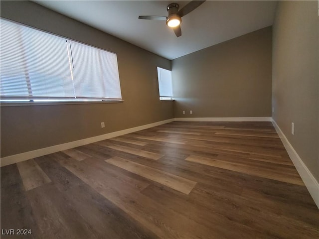 spare room featuring ceiling fan and dark wood-type flooring