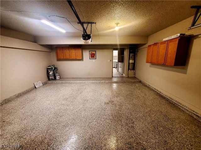 garage with a garage door opener and washer / dryer