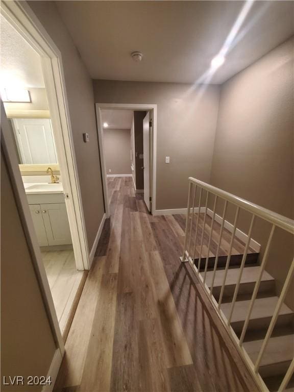 hallway featuring sink and wood-type flooring