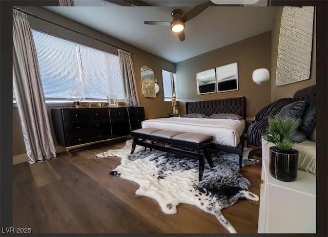 bedroom featuring ceiling fan and dark hardwood / wood-style flooring