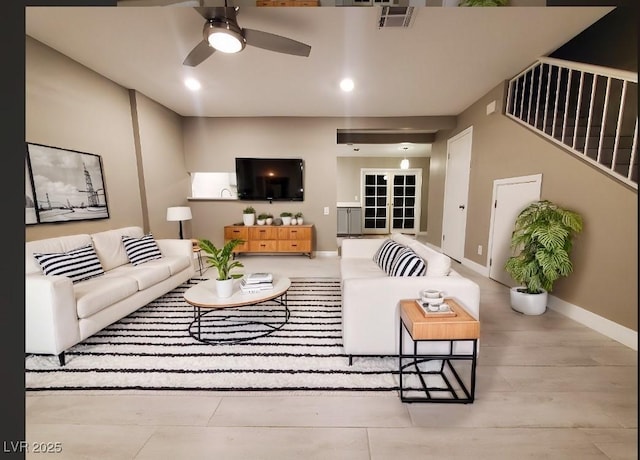 living room with visible vents, wood finished floors, french doors, baseboards, and ceiling fan