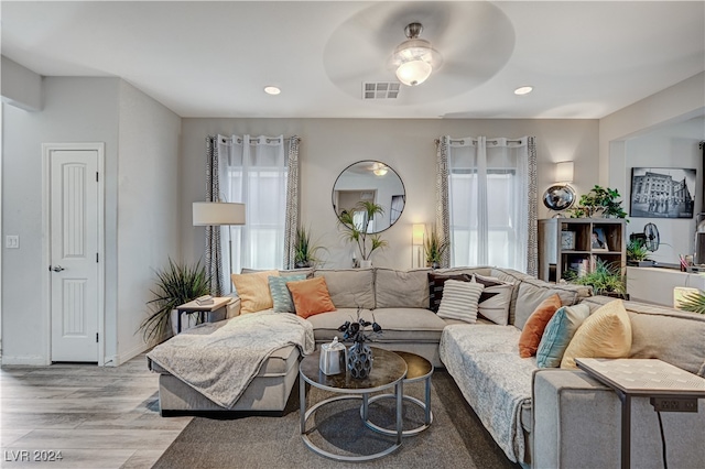 living room with ceiling fan and light wood-type flooring