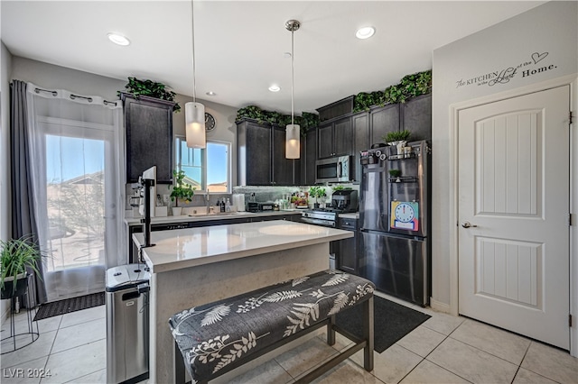 kitchen with stainless steel appliances, light tile patterned flooring, tasteful backsplash, a center island, and pendant lighting