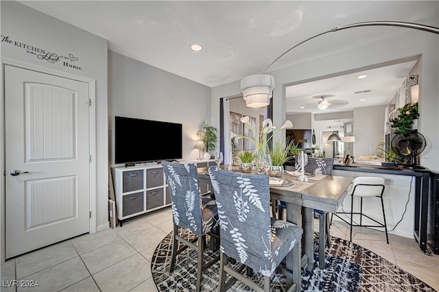 dining area featuring light tile patterned floors and ceiling fan