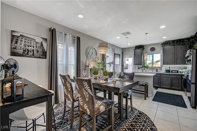 dining space featuring light tile patterned flooring