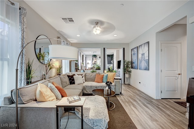 living room with hardwood / wood-style flooring and ceiling fan