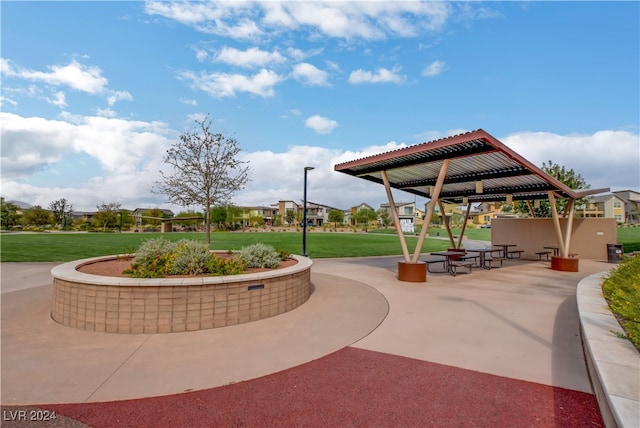 view of property's community with a patio and a yard