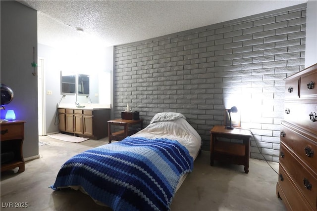 bedroom with concrete floors and a textured ceiling