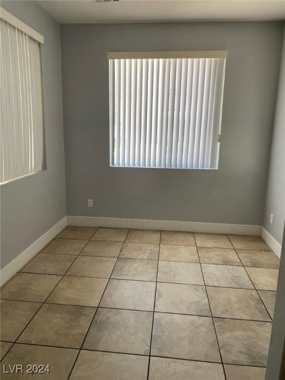 empty room with light tile patterned floors