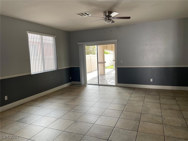 tiled empty room featuring ceiling fan