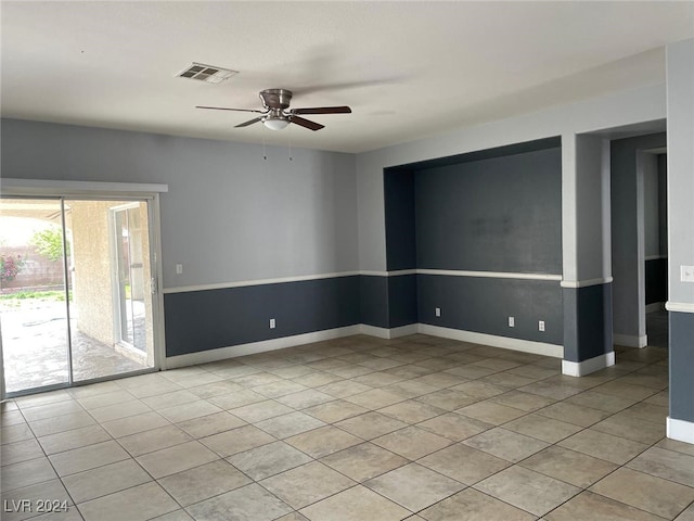 tiled spare room with ceiling fan