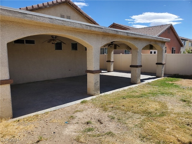 exterior space with a lawn, ceiling fan, and a patio area