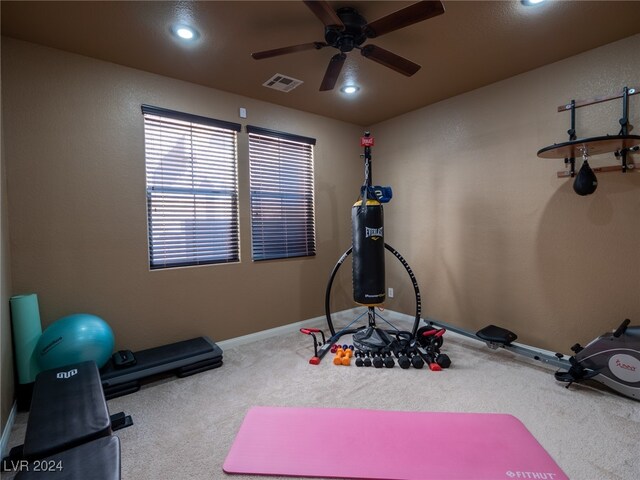 exercise area with ceiling fan and carpet floors