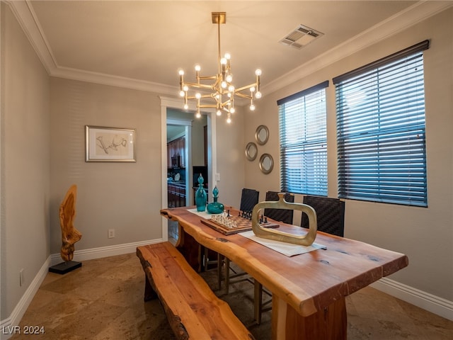 dining area with ornamental molding and a chandelier