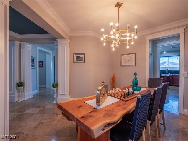 dining space with sink, ornamental molding, and decorative columns