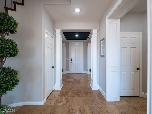 hall featuring decorative columns