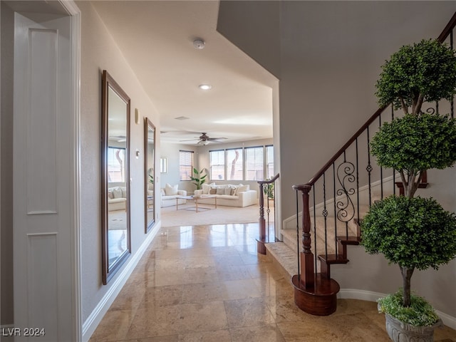 foyer entrance featuring ceiling fan