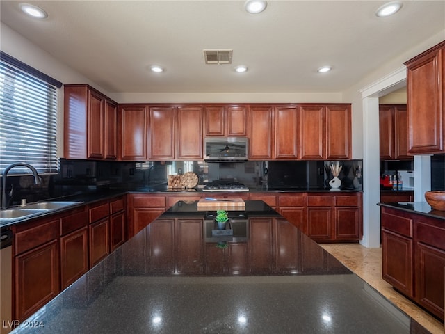 kitchen featuring sink, backsplash, and appliances with stainless steel finishes