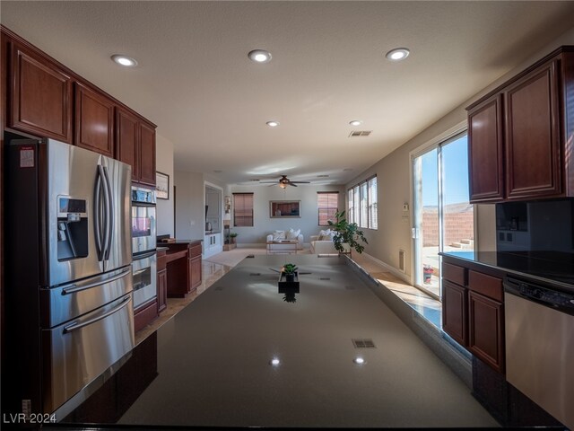 kitchen featuring ceiling fan and stainless steel appliances