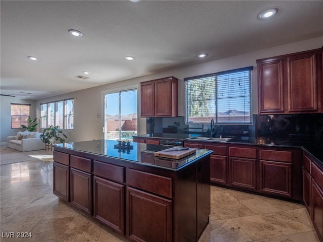 kitchen featuring dishwasher, a kitchen island, and sink