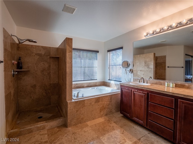 bathroom with vanity and independent shower and bath