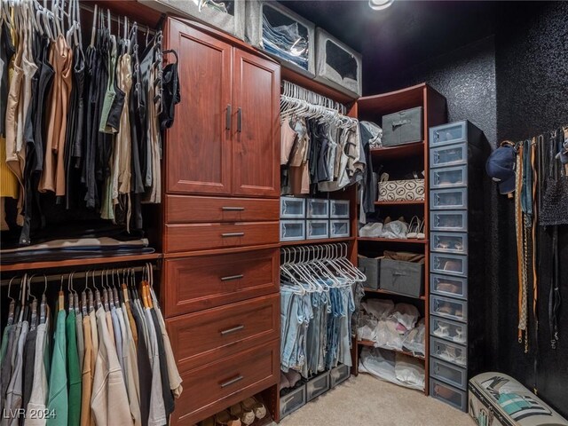 spacious closet featuring light carpet