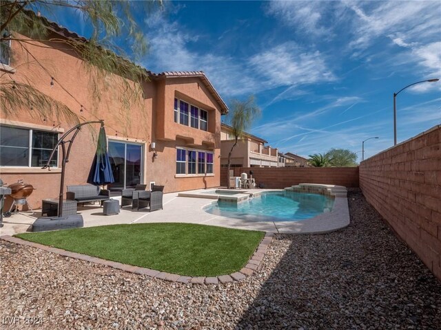 view of pool featuring a patio area, outdoor lounge area, and an in ground hot tub