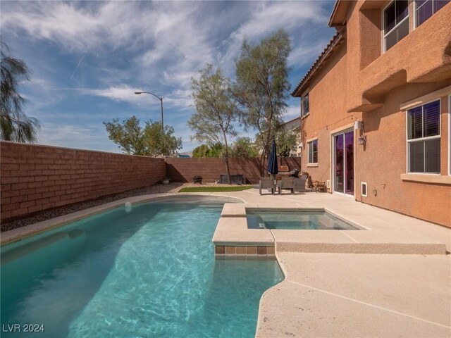 view of pool featuring an in ground hot tub and a patio