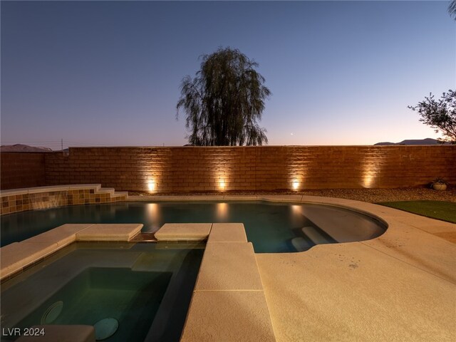 view of pool at dusk