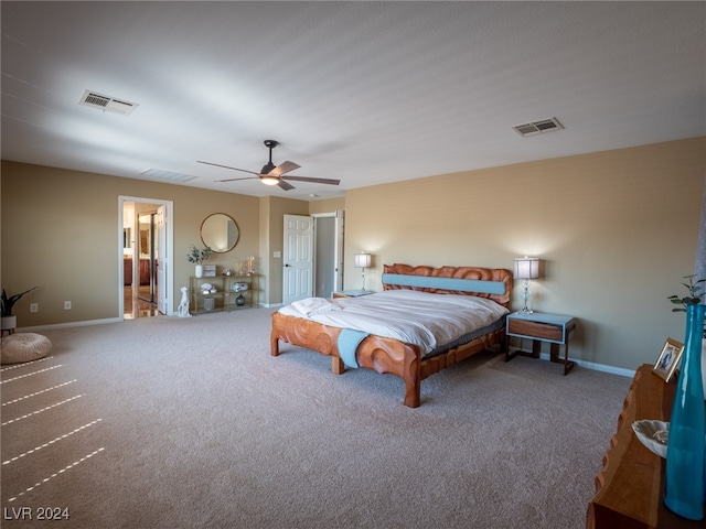 bedroom with ceiling fan, connected bathroom, and carpet flooring