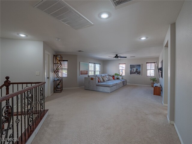 living room featuring light carpet and a wealth of natural light