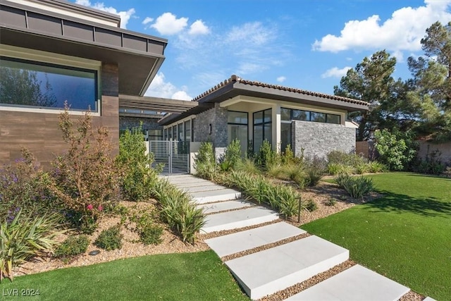 1 Olympia Canyon Way, Las Vegas, NV 89141 - view of exterior entry with a yard, stone siding, and a tile roof