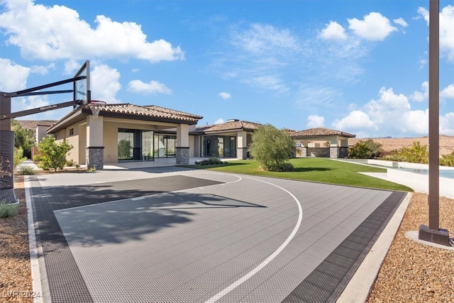 view of basketball court with a lawn