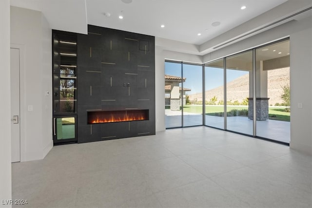 unfurnished living room featuring a mountain view and a fireplace