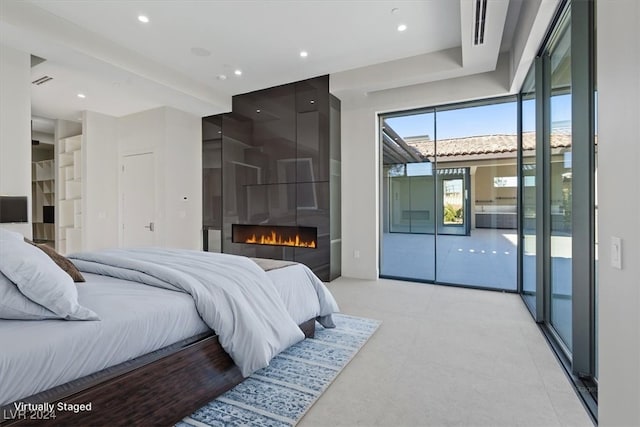 bedroom featuring access to exterior, recessed lighting, visible vents, and a large fireplace