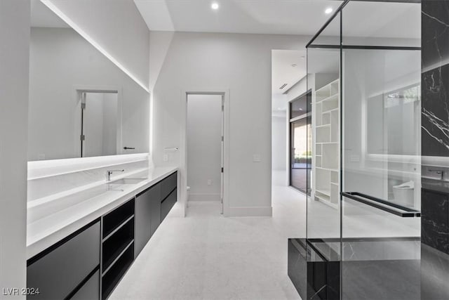 bathroom with vanity, recessed lighting, baseboards, and a towering ceiling