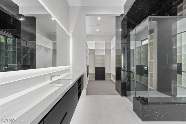 bathroom featuring vanity and a walk in closet