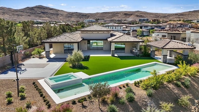 1 Olympia Canyon Way, Las Vegas, NV 89141 - rear view of property with a mountain view, stucco siding, a patio, a pool with connected hot tub, and a residential view