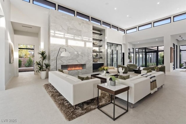 1 Olympia Canyon Way, Las Vegas, NV 89141 - living room with a high ceiling, a premium fireplace, and recessed lighting