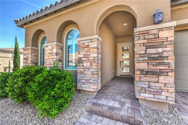 view of exterior entry featuring a garage