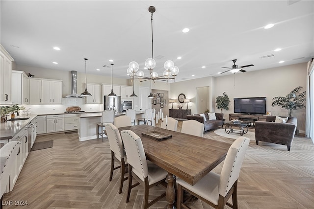 dining area featuring ceiling fan with notable chandelier and light parquet floors